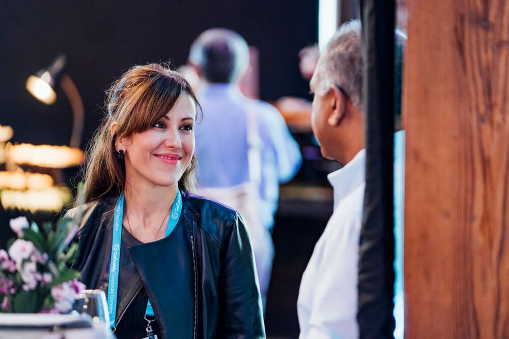 An engaging discussion between two guests at the TikTok Shop event, highlighting the friendly and collaborative environment of the reception.