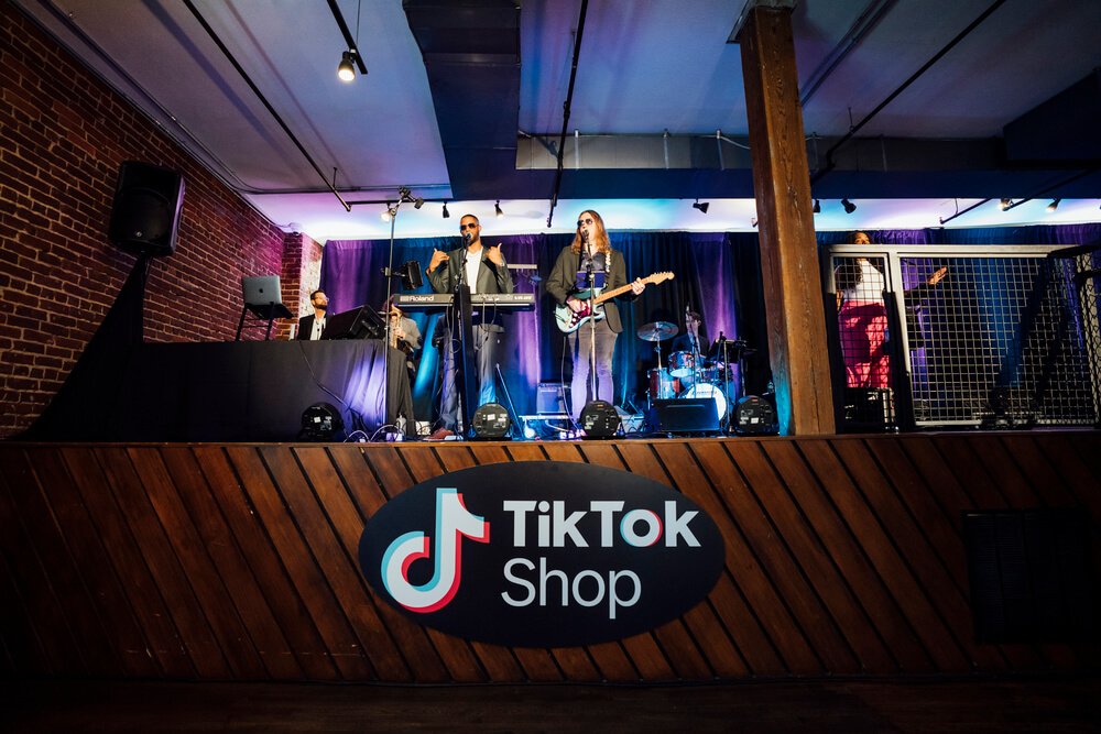 A live musical performance on stage at the TikTok Shop event, providing entertainment and a vibrant atmosphere for guests.