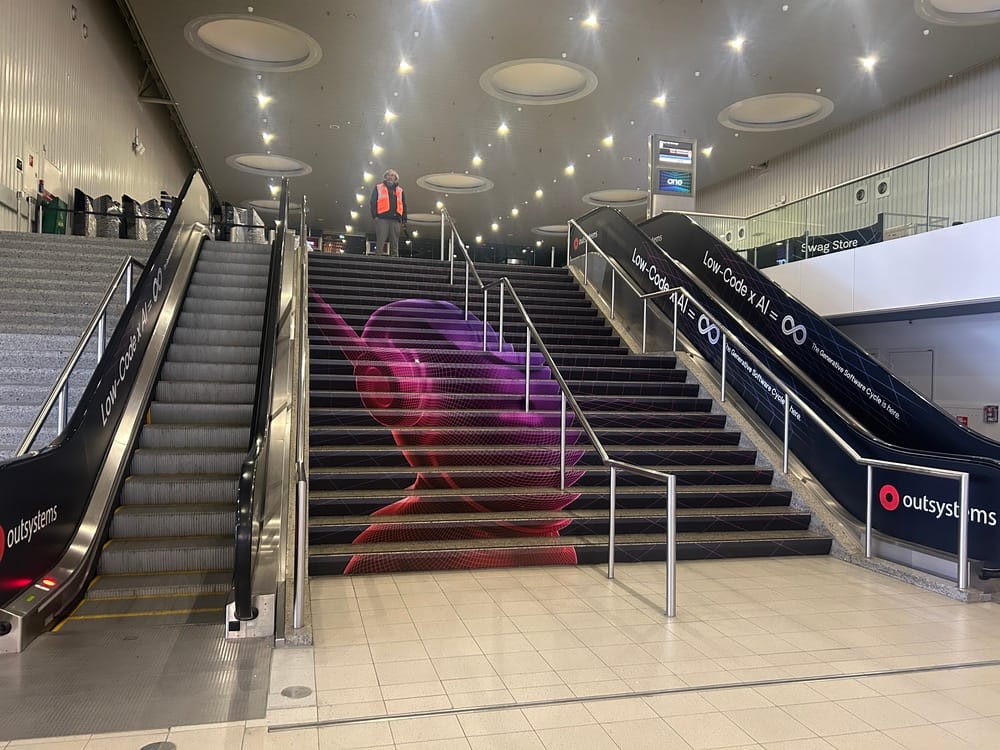 Event venue stairs with OutSystems branding and purple design