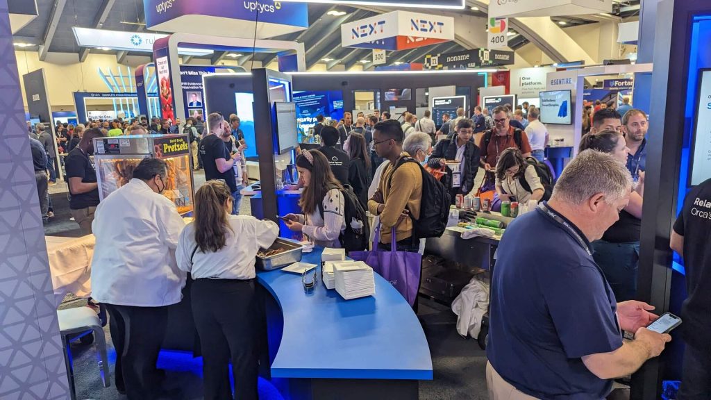 Attendees at Orca Security conference expo booth